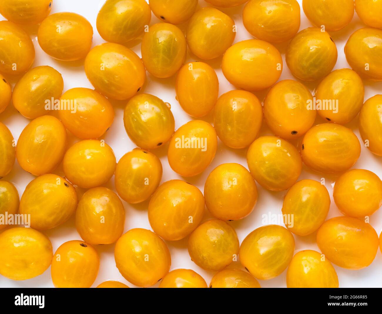 High angle view of full frame image of bright yellow tomatoes. Stock Photo