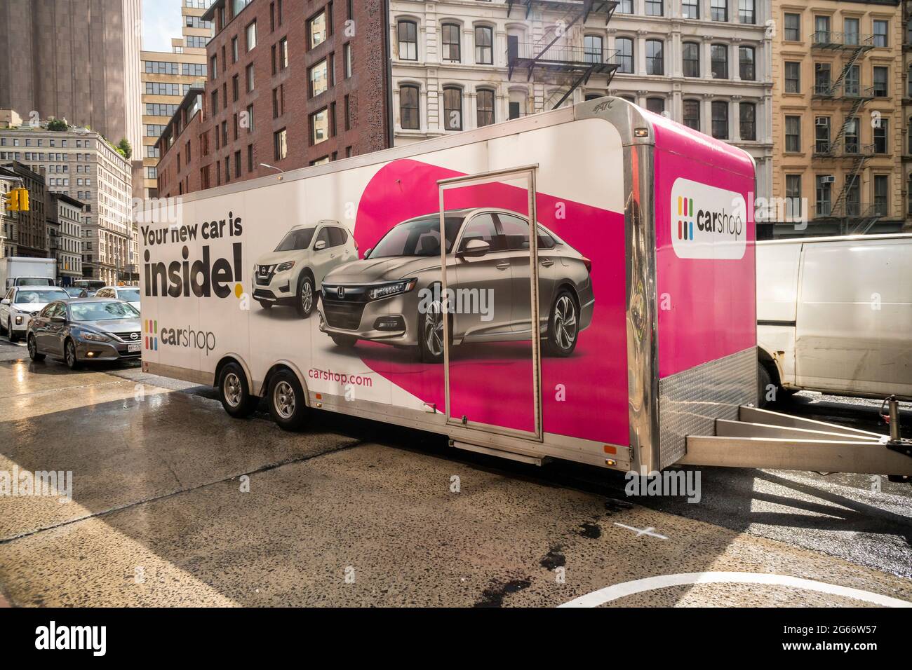 A trailer delivering a vehicle purchased on the online automobile supermarket, CarShop travels through the traffic of New York on Sunday, June 26, 2021. (© Richard B. Levine) Stock Photo