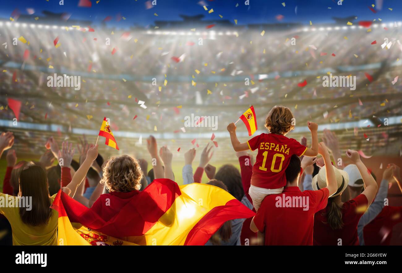 Spain football supporter on stadium. Spanish fans on soccer pitch watching  team play. Group of supporters with flag and national jersey cheering Stock  Photo - Alamy