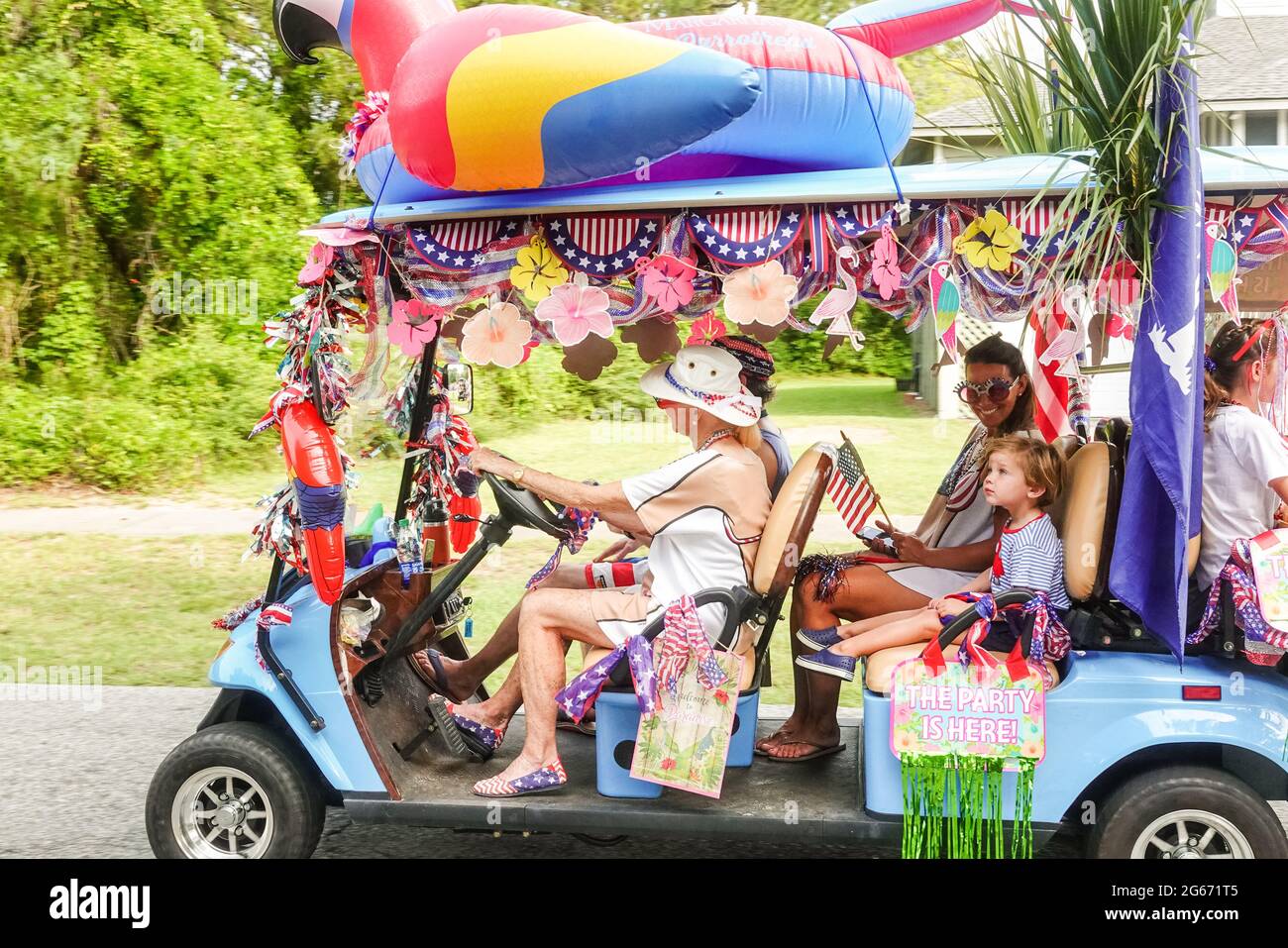 Sullivans Island, South Carolina, USA. 3rd July, 2021. A family drives their decorated golf cart during the annual Bicycle and Golf cart parade celebrating Independence Day July 3, 2021 in Sullivans Island, South Carolina. Credit: Planetpix/Alamy Live News Stock Photo