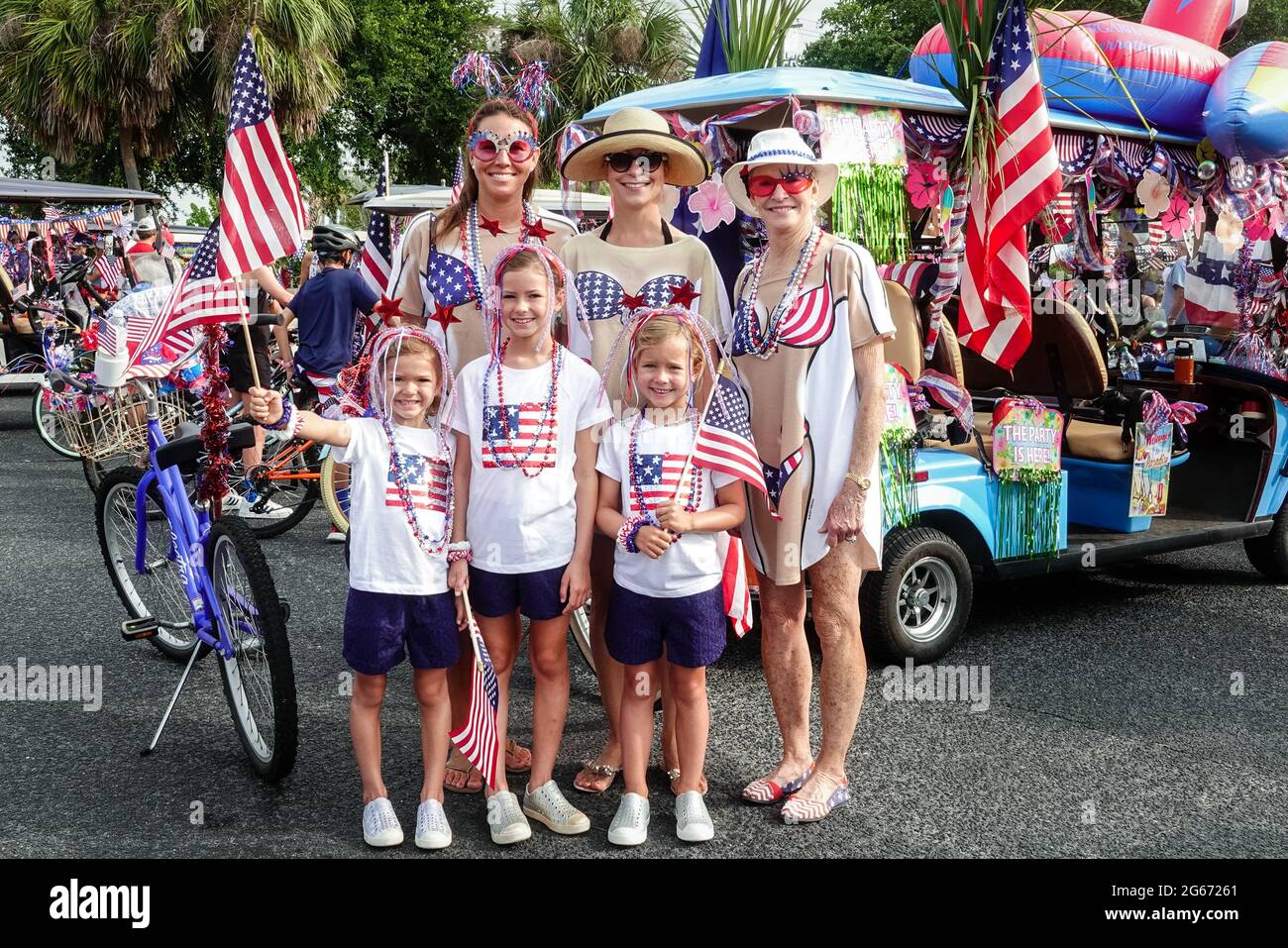 Sullivans Island, South Carolina, USA. 3rd July, 2021. A family wearing patriotic costumes during the annual Bicycle and Golf cart parade celebrating Independence Day July 3, 2021 in Sullivans Island, South Carolina. Credit: Planetpix/Alamy Live News Stock Photo