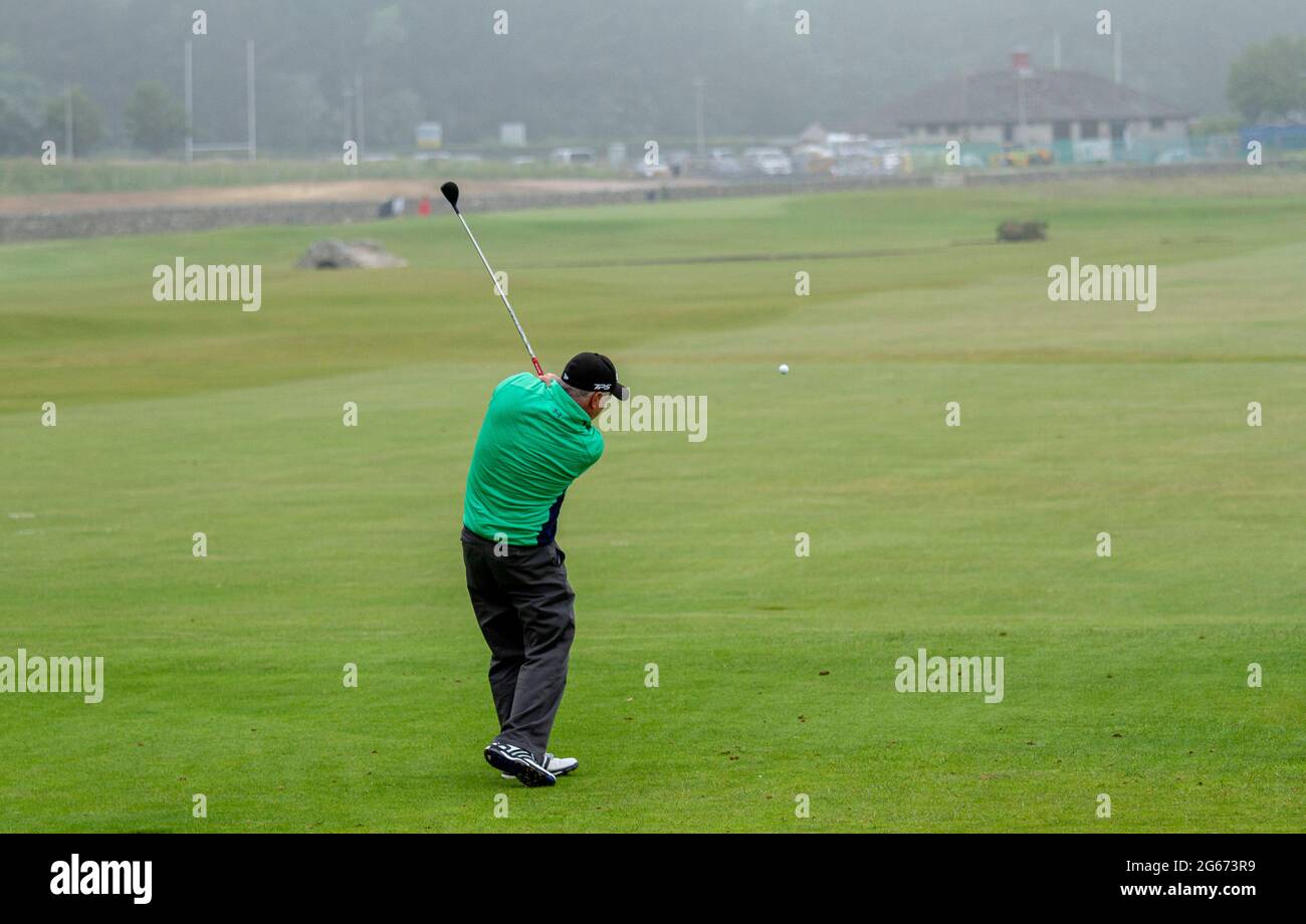 St Andrews, Fife, Scotland, UK. 3rd July, 2021. UK Weather: A cool misty day across North East Scotland with temperatures reaching 15°C. A senior man takes the day out to enjoy a game of golf at The Old Course at St Andrews Links. Credit: Dundee Photographics/Alamy Live News Stock Photo