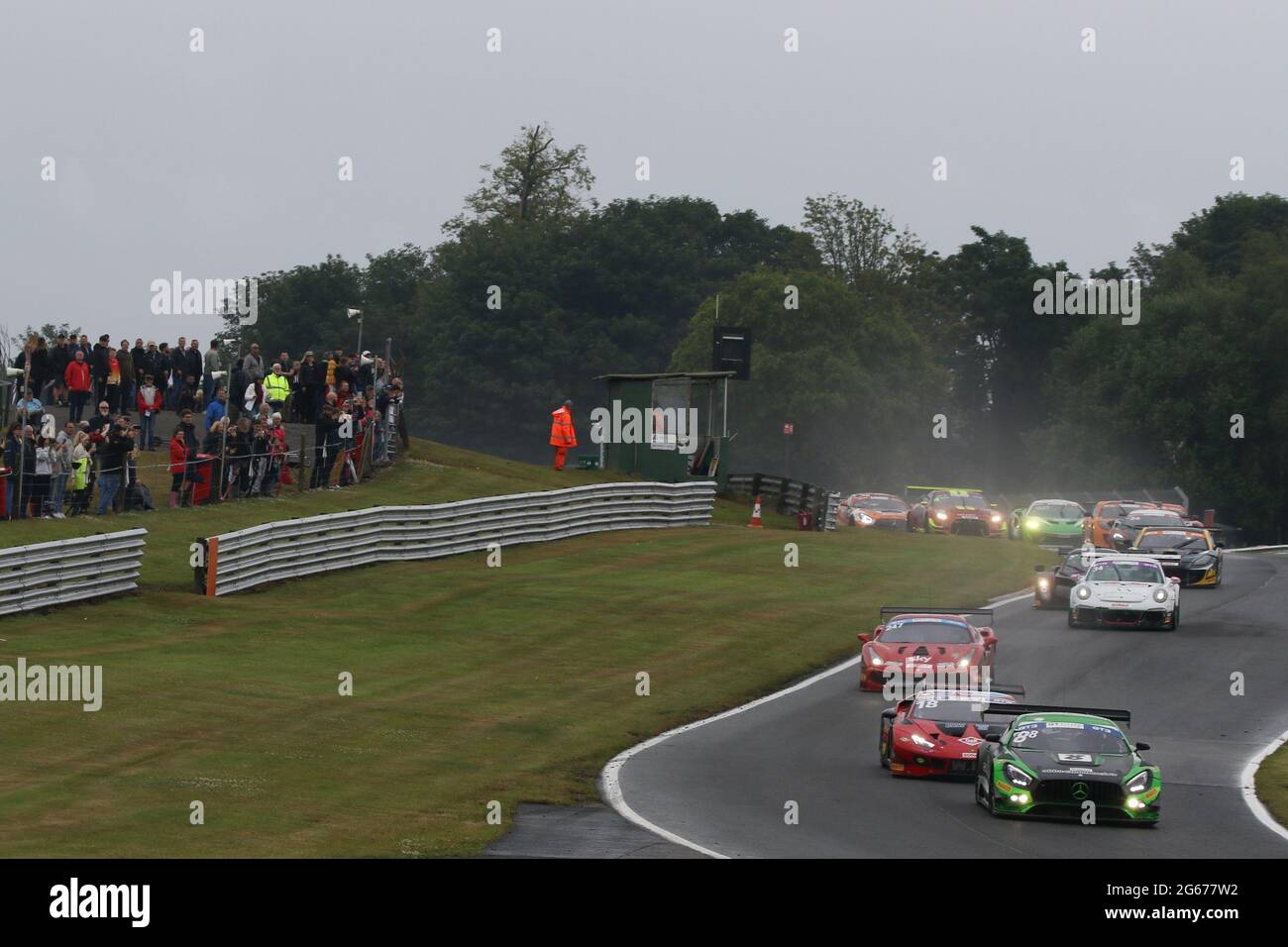 Oulton Park, Cheshire, UK. 03rd July, 2021. Abba Racing Mercedes AMG GT3 ( 88 ) driven by Richard Neary/Sam Neary (Pro-sport) leads into Cascades corner on the opening lap of race 1 during the GT Cup Championship at Oulton Park, Cheshire, England on 03 July 2021. Photo by Jurek Biegus. Credit: Jurek Biegus/Alamy Live News Stock Photo