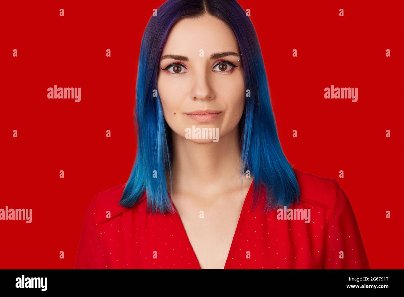 Happy young woman in red dress with blue hair on red background Stock Photo  - Alamy