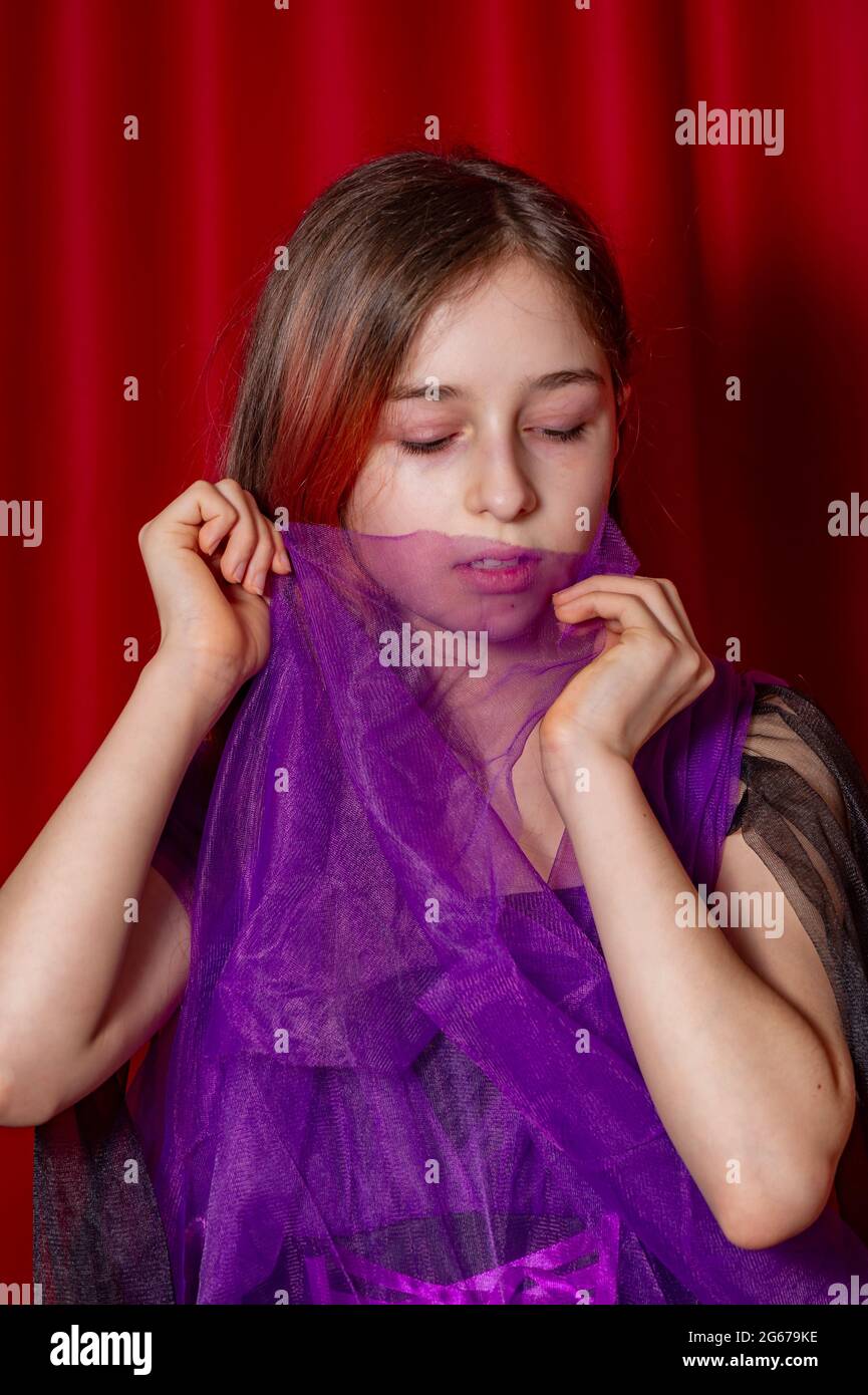 Portrait of a teenage girl in purple with a black dress Stock Photo - Alamy