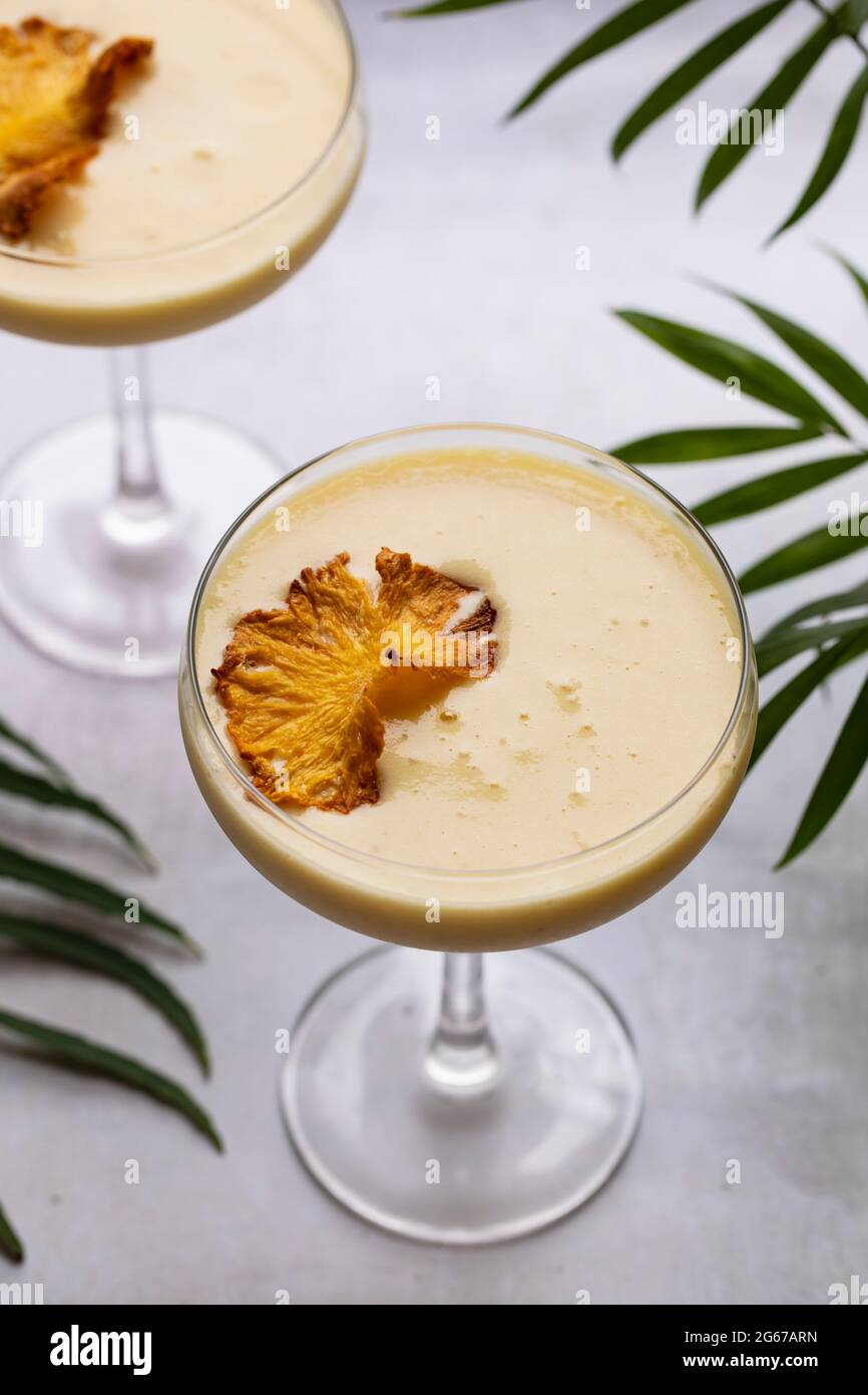 Pineapple cocktail with crispy pineapple garnish Stock Photo Alamy