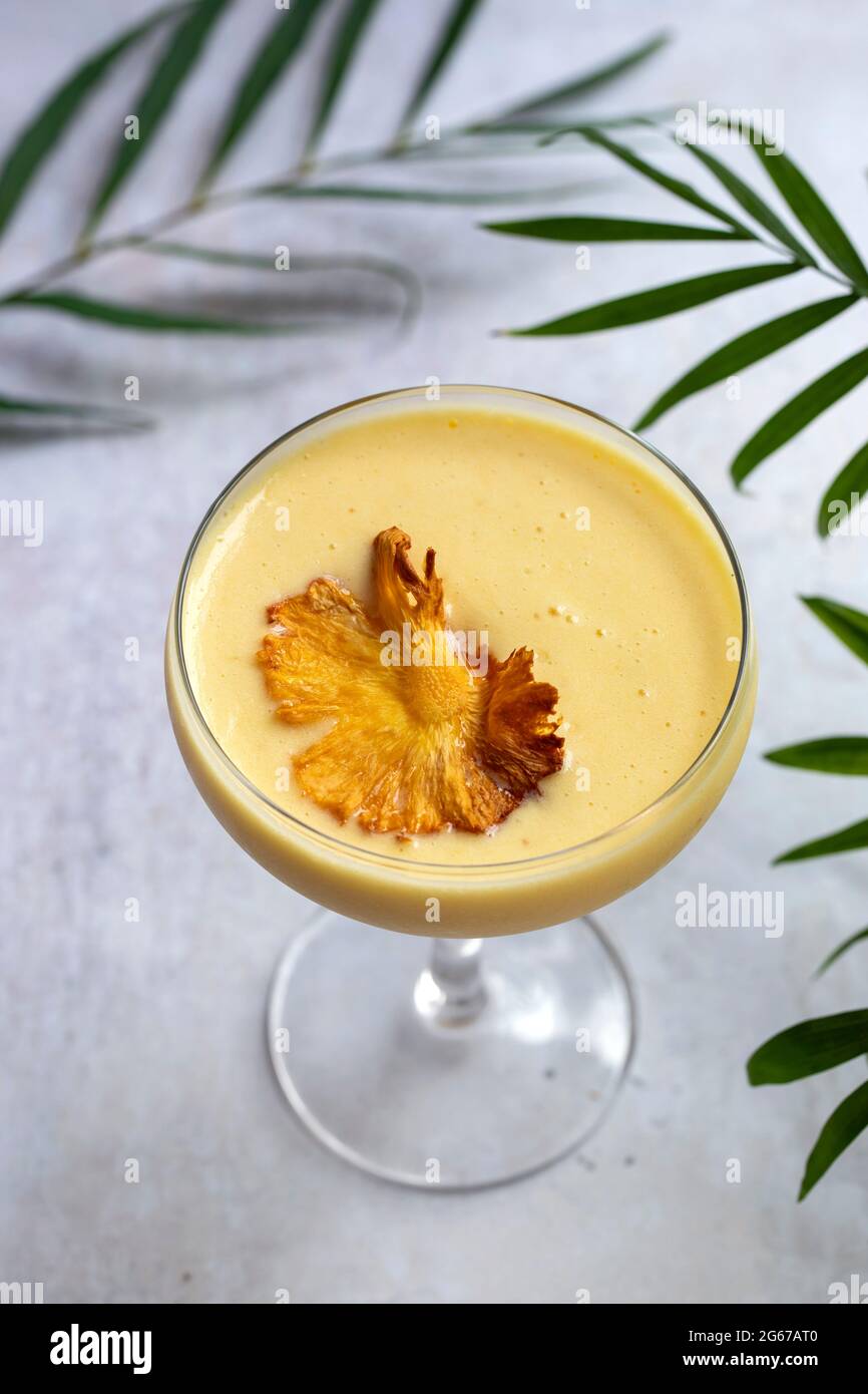 Pineapple cocktail with crispy pineapple garnish Stock Photo Alamy