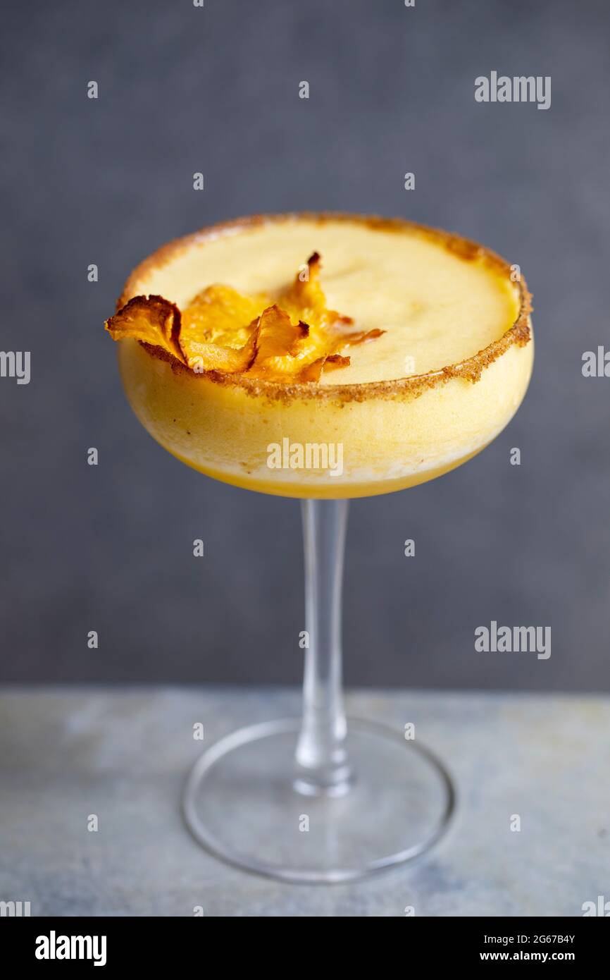 Pineapple cocktail with crispy pineapple garnish Stock Photo Alamy