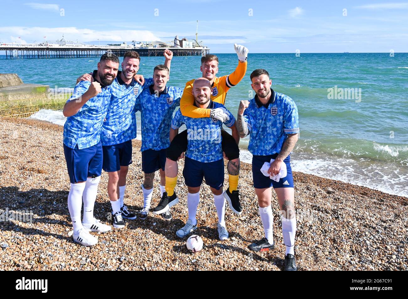 Brighton  UK 3rd July 2021 - A group of England fans on Brighton  beach before tonights European Championship quarter final match against Ukraine  : Credit Simon Dack / Alamy Live News Stock Photo