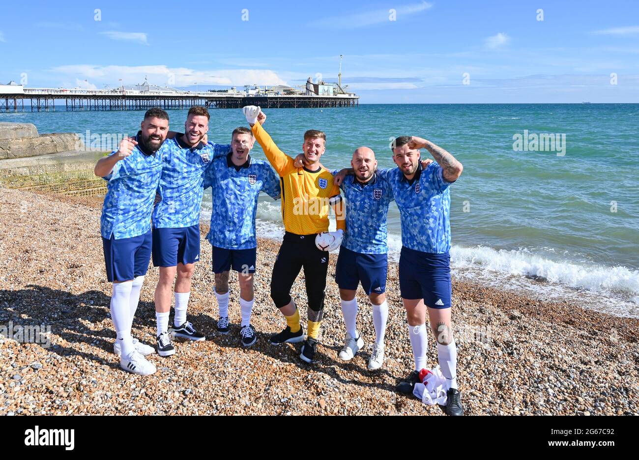 Brighton  UK 3rd July 2021 - A group of England fans on Brighton  beach before tonights European Championship quarter final match against Ukraine  : Credit Simon Dack / Alamy Live News Stock Photo