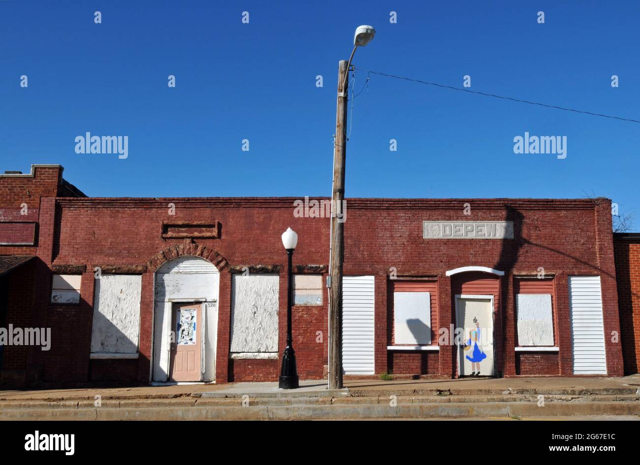 Historic buildings with boarded-up storefronts stand along Main Street in the Route 66 town of Depew, Oklahoma. Stock Photo