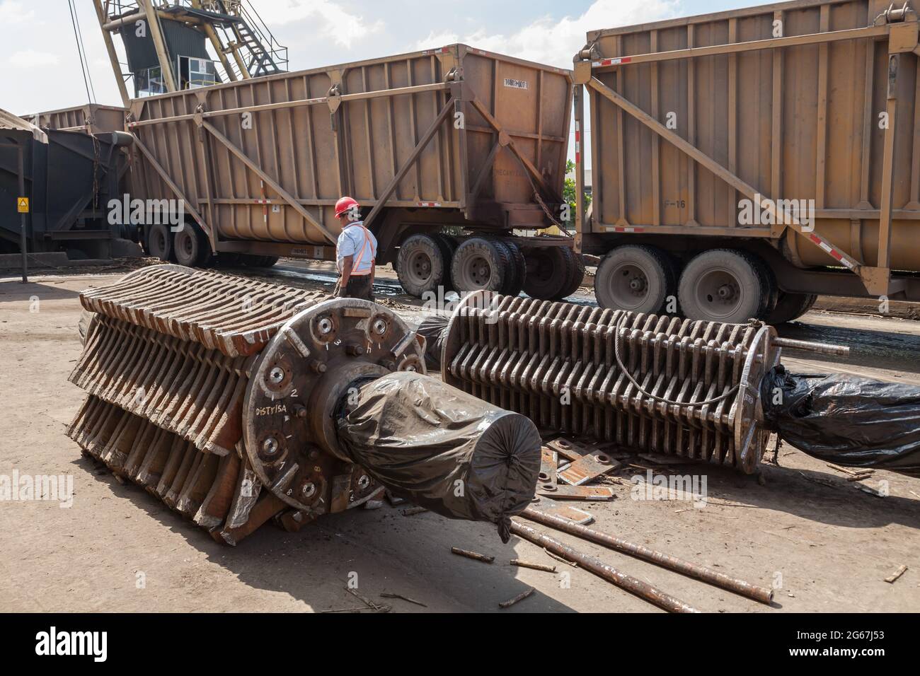 Replacement grinding wheels at a sugarcane refinery await fitting while a transporter is offloaded Stock Photo
