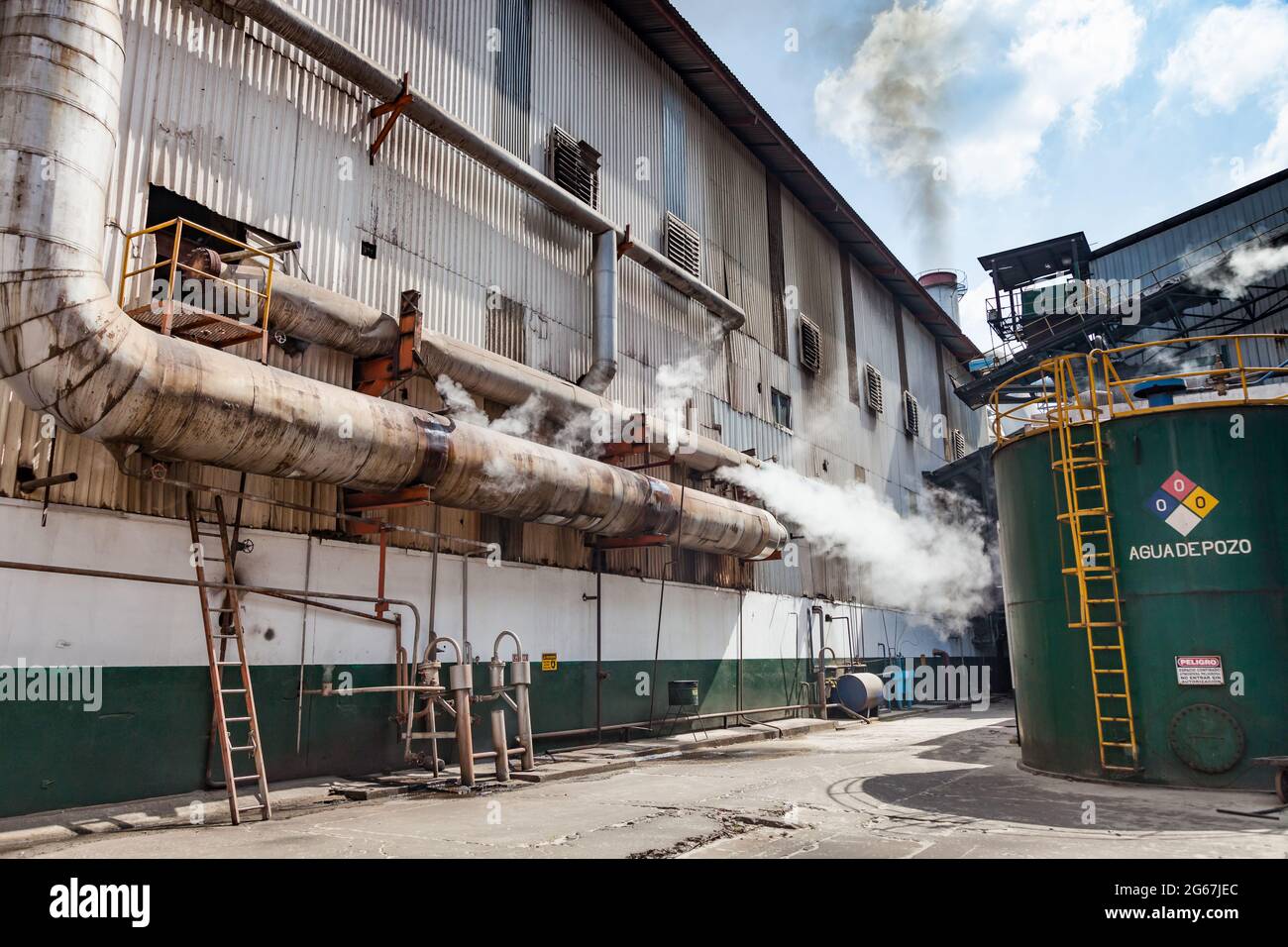 External view of a sugar refinery with vapour escaping vents Stock Photo