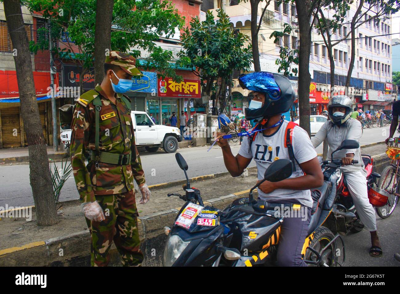 Dhaka, Bangladesh. 03rd July, 2021. Law and military enforcer checking people's ID card, pass and necessary papers and asking the reason why they are out despite strict lockdown in Dhaka. (Photo by MD IBRAHIM/Pacific Press) Credit: Pacific Press Media Production Corp./Alamy Live News Stock Photo