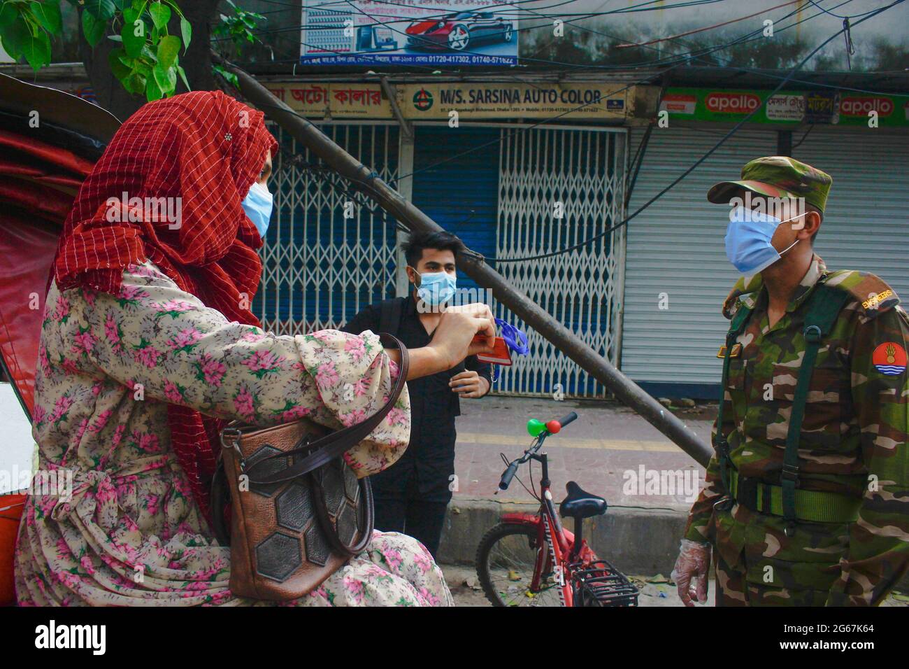 Dhaka, Bangladesh. 03rd July, 2021. Law and military enforcer checking people's ID card, pass and necessary papers and asking the reason why they are out despite strict lockdown in Dhaka. (Photo by MD IBRAHIM/Pacific Press) Credit: Pacific Press Media Production Corp./Alamy Live News Stock Photo