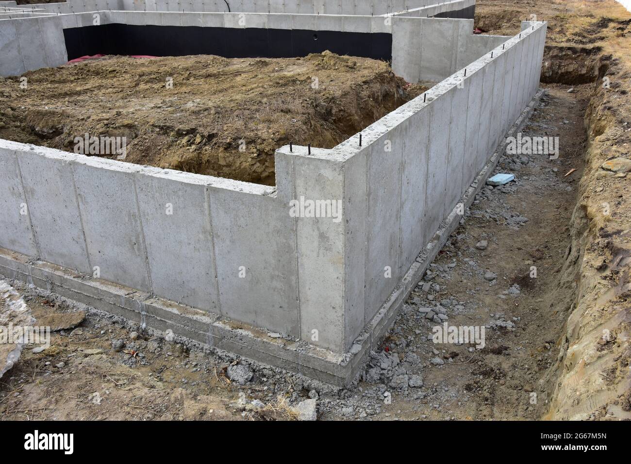 Concrete footings and basement walls complete ready for next step in construction process for residential home. Stock Photo