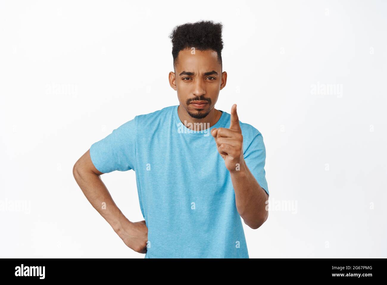 Behave yourself. Serious young african american guy shaking finger to scold  you, frowning and squinting, give warning, prohibit smth bad, standing  Stock Photo - Alamy