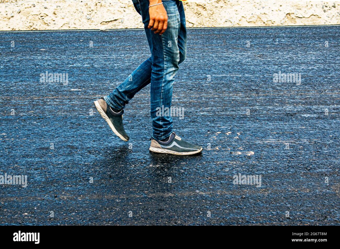 Legs of a man walking on an asphalt road. Walking Stock Photo Alamy