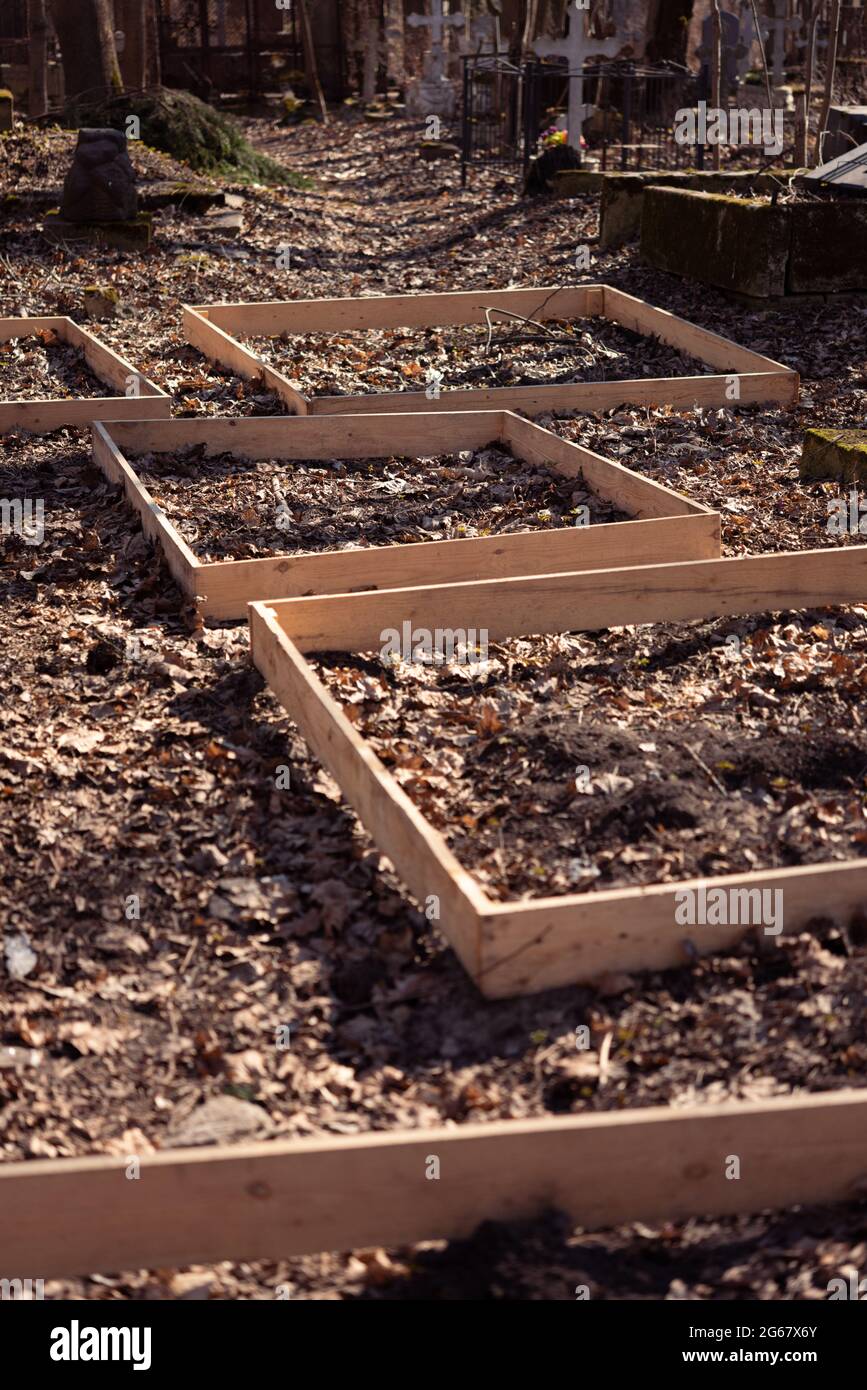 Plank frames defining sites for new graves at a Russian cemetery in St. Petersburg, Russia. Stock Photo