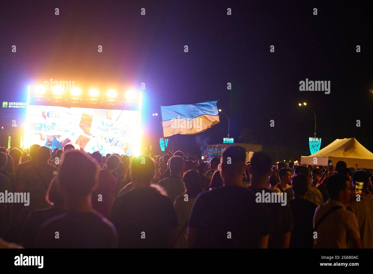 KHARKIV, UKRAINE - JULY 3, 2021: EURO 2020 Ukraine - England. Ukrainian soccer fans cheer at the Fan Zone in Kharkiv Stock Photo