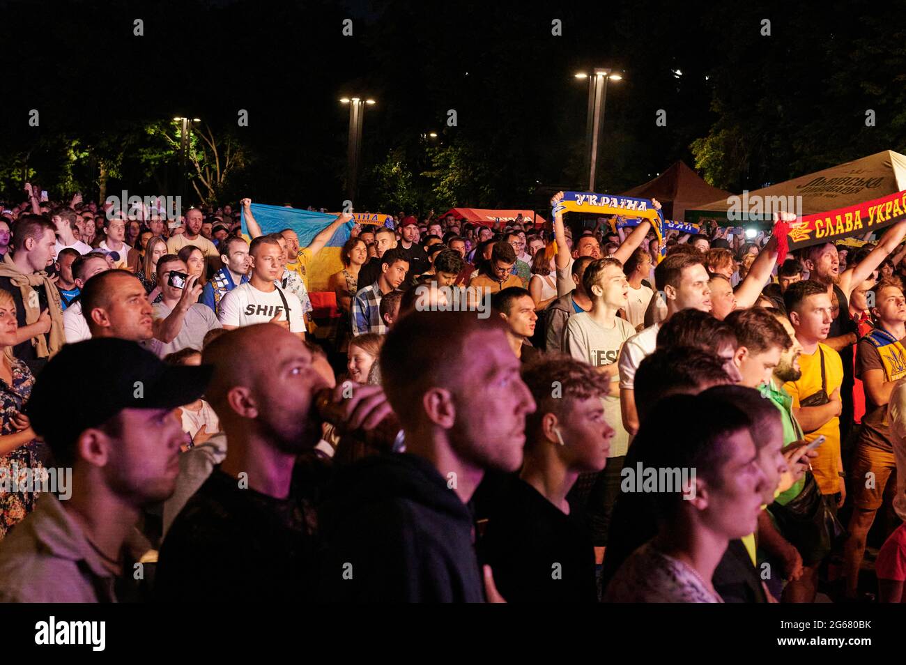 KHARKIV, UKRAINE - JULY 3, 2021: EURO 2020 Ukraine - England. Ukrainian soccer fans cheer at the Fan Zone in Kharkiv Stock Photo