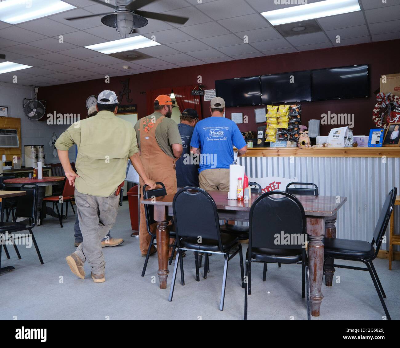 Group of people, men, at the order counter at the small town, country, restaurant, Bones Backstreet BBQ in Clanton Alabama, USA. Stock Photo