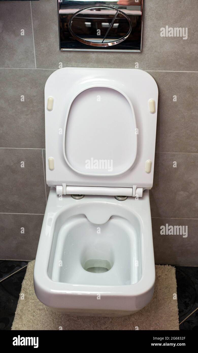 White toilet bowl in the interior, modern toilet. Disinfection of the toilet,  cleaning the toilet, washing away dirt from the toilet, flushing away Stock  Photo - Alamy
