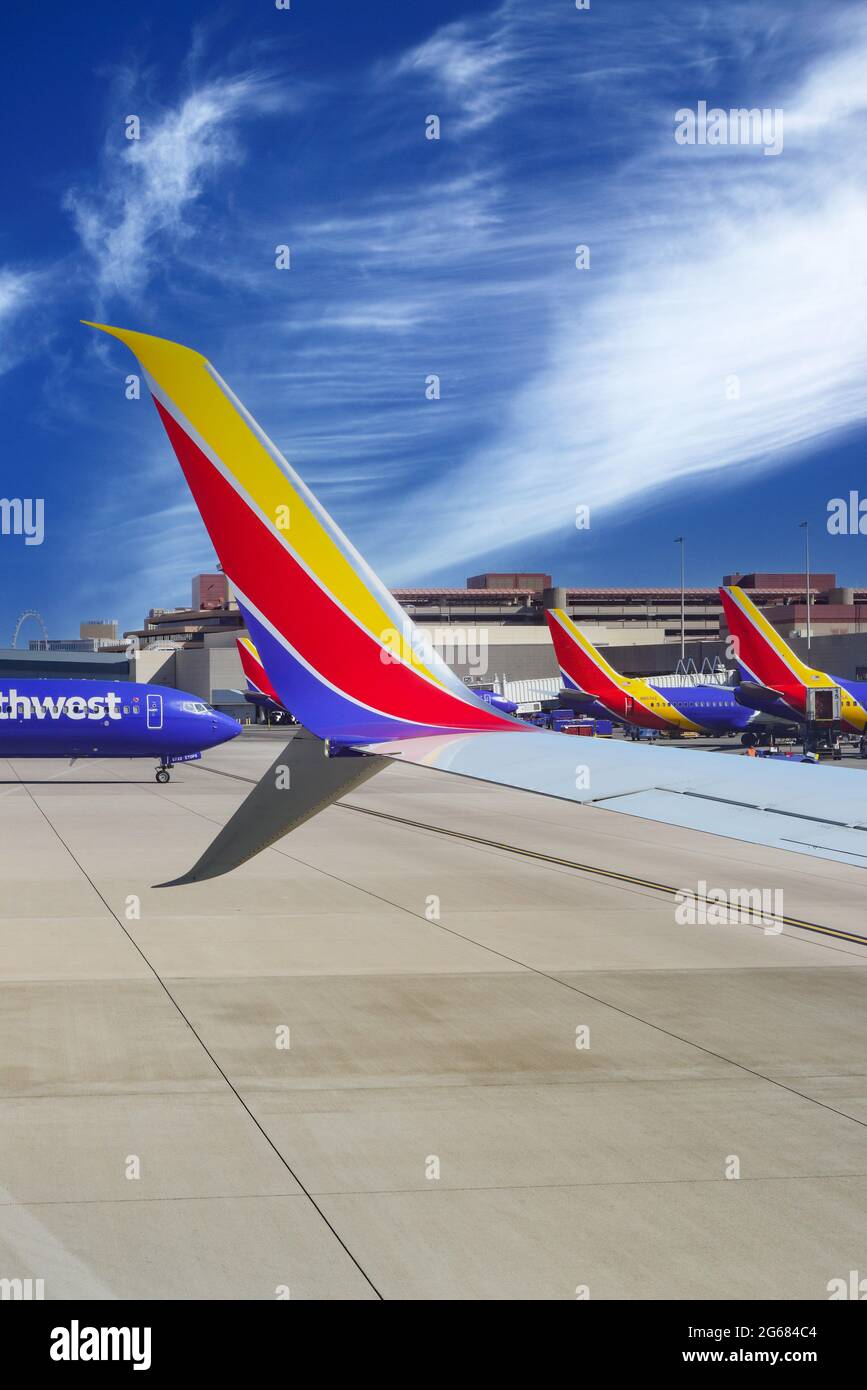 A colorful Southwest Airlines wing in formation with other Southwest planes at gates at Las Vegas MaCarran International Airport in Nevada Stock Photo
