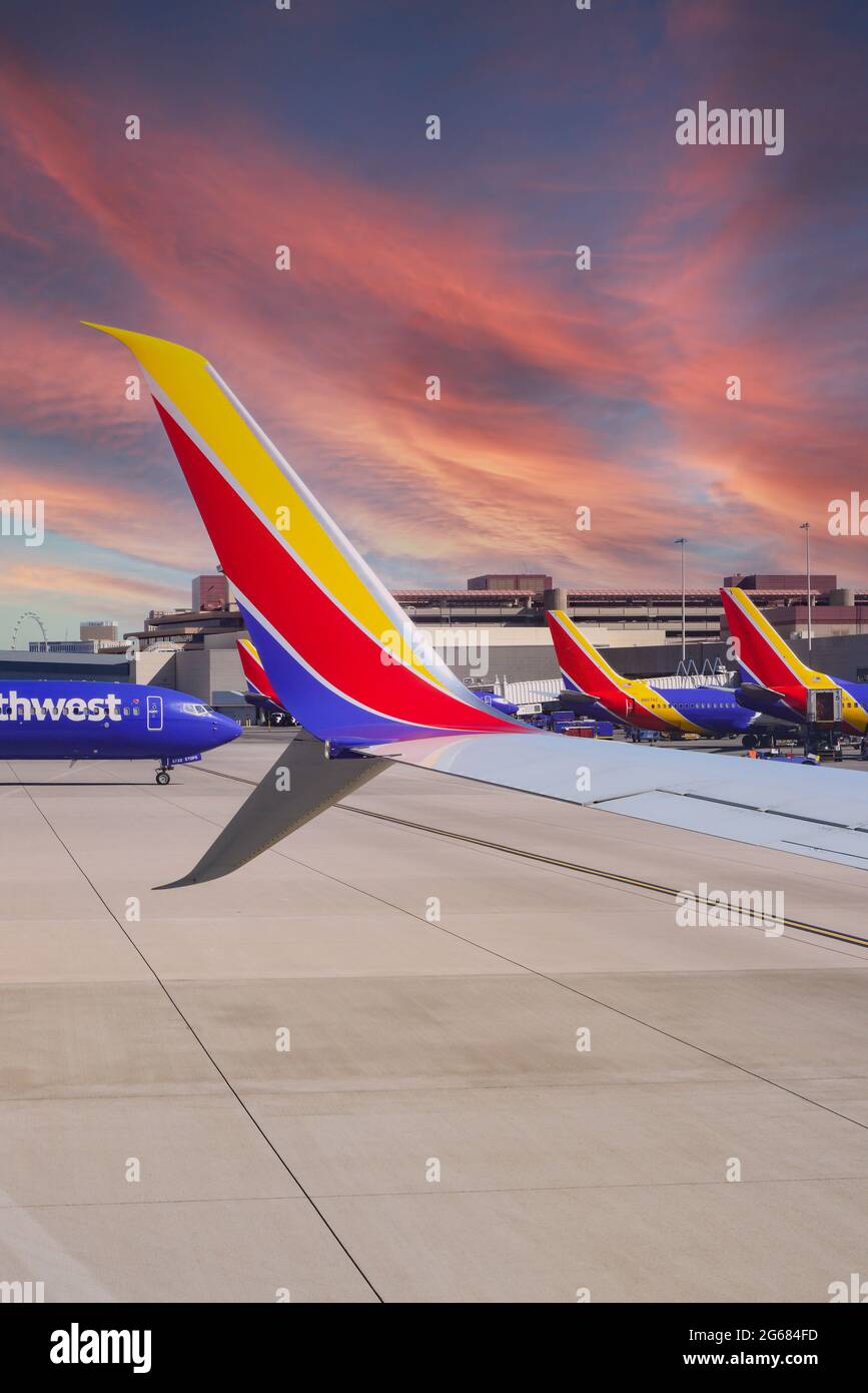A colorful Southwest Airlines wing in formation with other Southwest planes at gates at Las Vegas MaCarran International Airport in Nevada Stock Photo