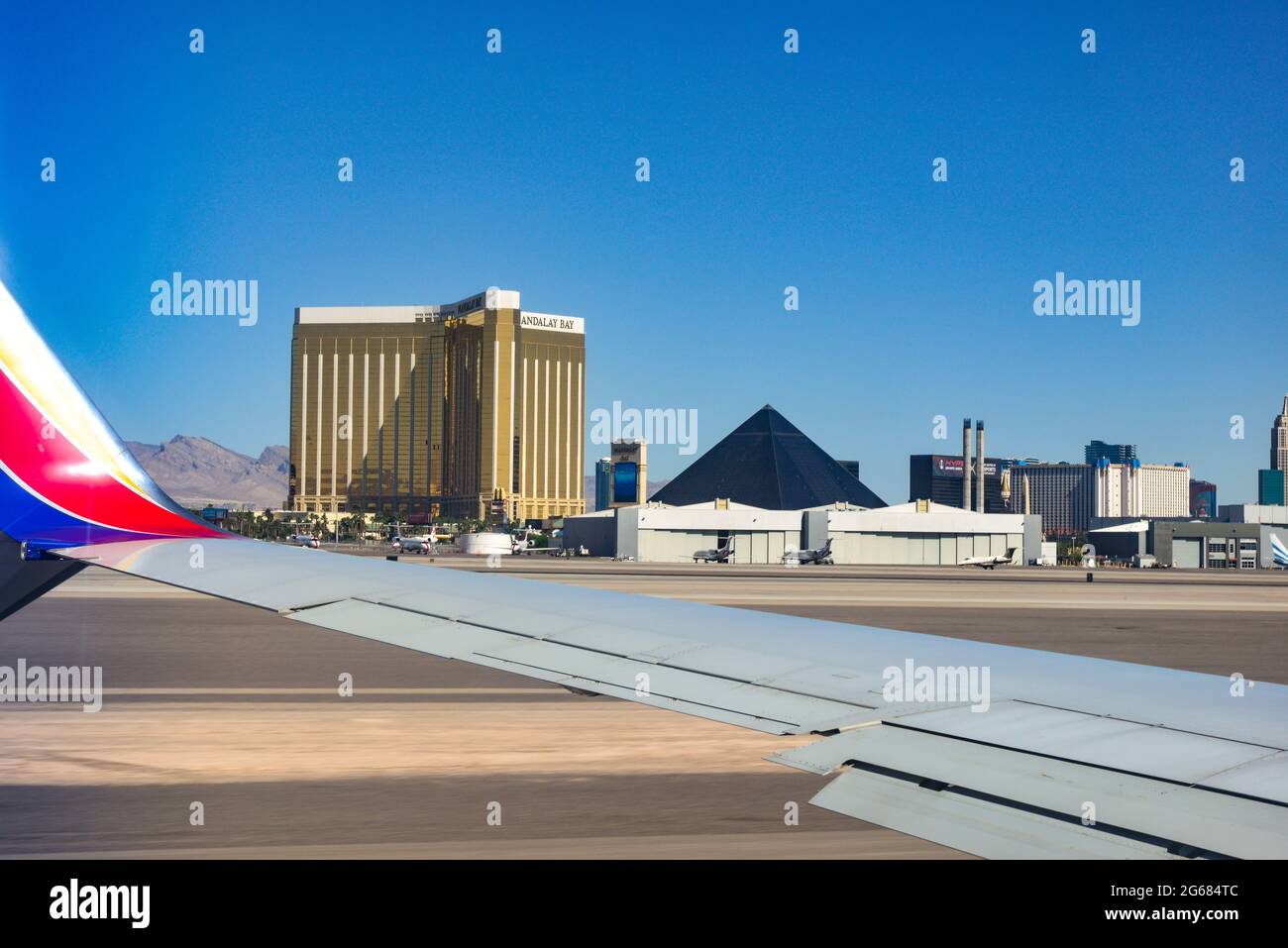 View from a window  seat in the 780 Max airplane of wing and the backside of casinos on the Strip at Las Vegas MaCarran International airport, LV, NV Stock Photo