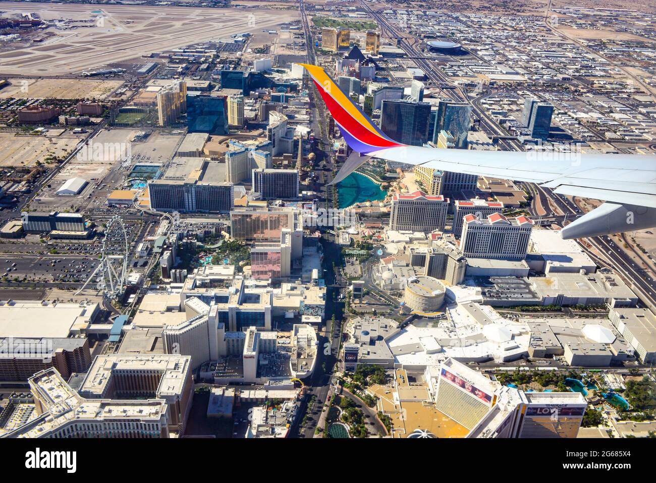 A wing tip of a 780 Max airplane in the foreground aerial view of the Vegas strip after liftoff from Las Vegas McCarran International Airport, NV Stock Photo