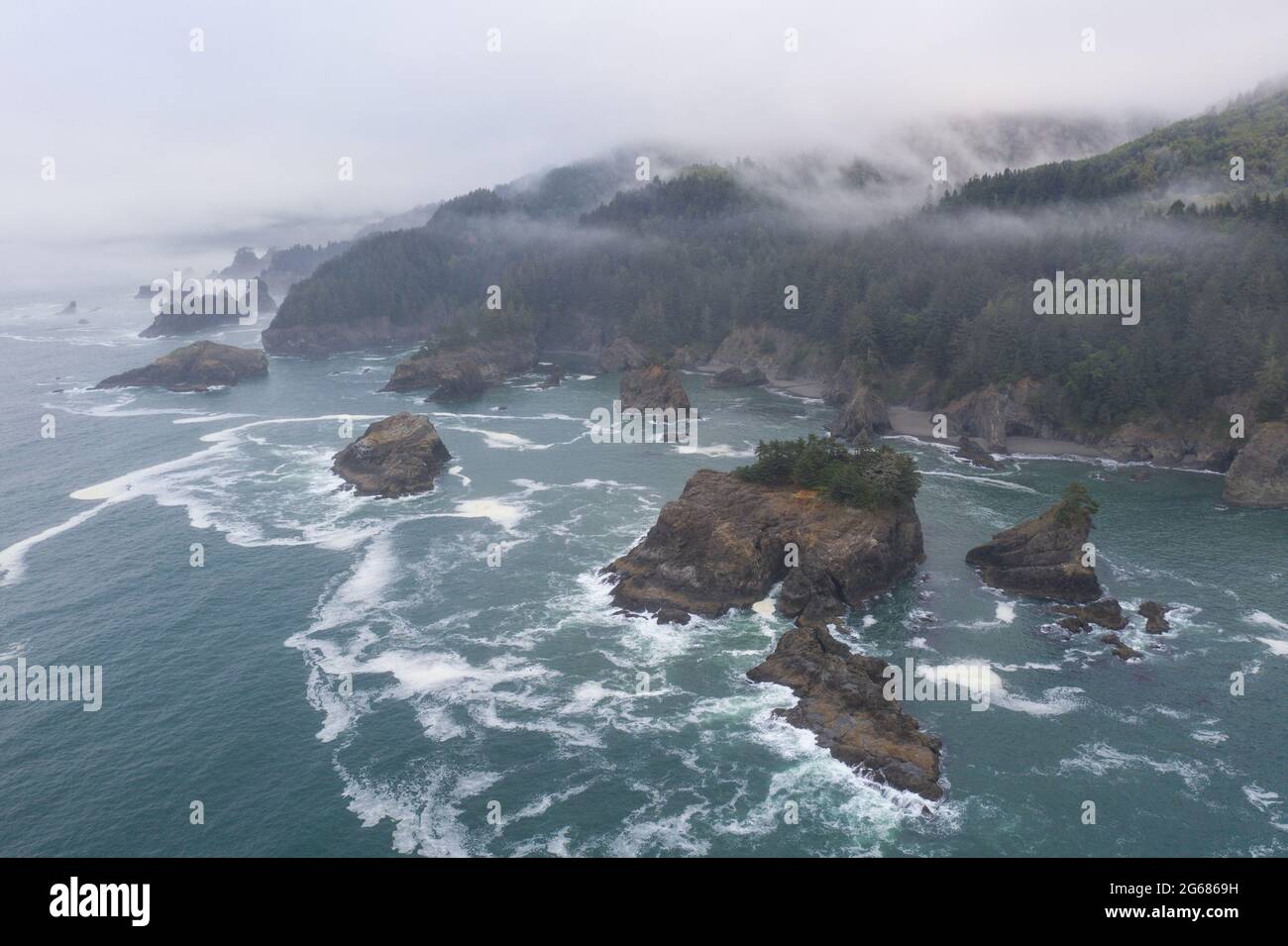 The cold Pacific Ocean washes against the scenic, rugged coastline of ...