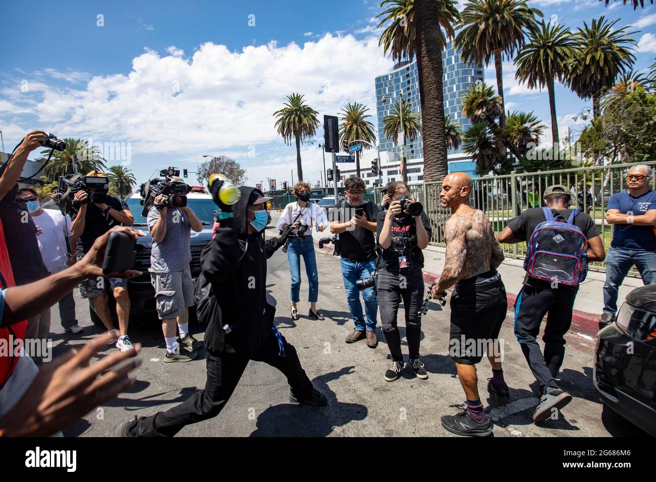 Los Angeles, California, USA. 3rd July, 2021. Protesters in support of transgender rights face off with a counter-protester in a neighborhood near the Wi Spa in the Koreatown area of Los Angeles. They had gathered to support the business after a viral video complained that they allowed a transgender woman in the spa. Credit: Jill Connelly/ZUMA Wire/Alamy Live News Stock Photo