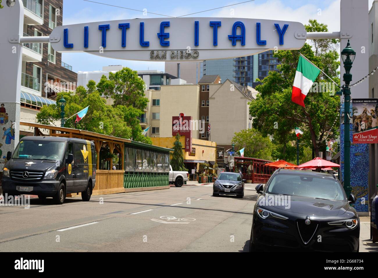 A late model Alpha Roma Giulia car parked under the overhead sign for Little Italy neighborhood near the waterfront in San Diego, CA, USA Stock Photo