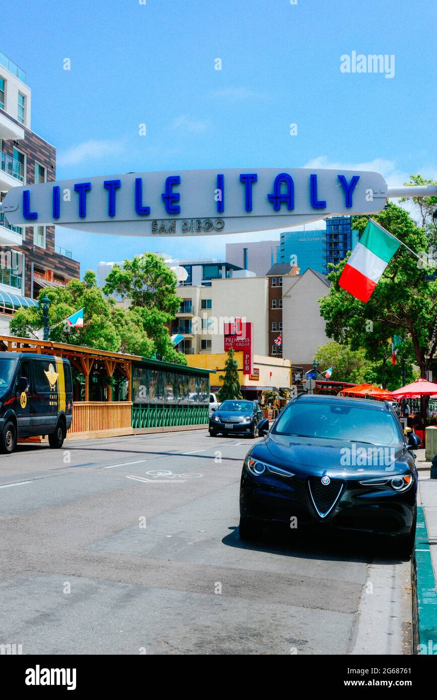 A late model Alpha Roma Giulia car parked under the overhead sign for Little Italy neighborhood near the waterfront in San Diego, CA, USA Stock Photo