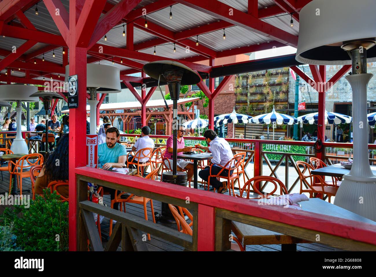 People enjoy the trendy eateries that line India Street with outdoor patio seating in the 'Little Italy' district of downtown San Diego, CA, USA Stock Photo