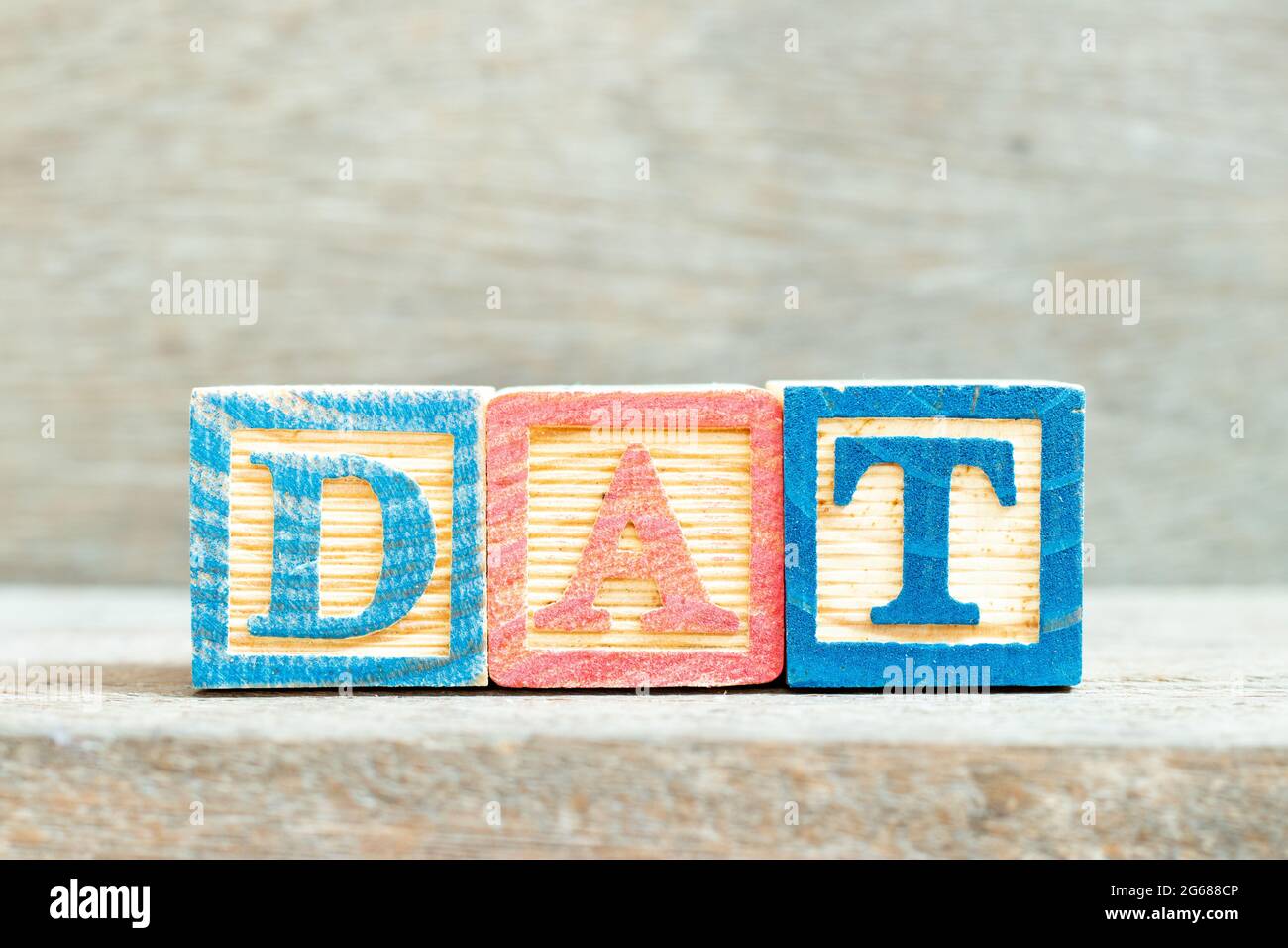 Color alphabet letter block in word DAT (Abbreviation of Delivery at Terminal) on wood