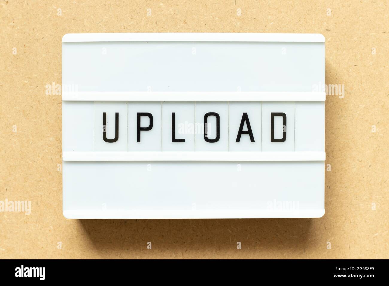 Lightbox with word upload on wood background Stock Photo