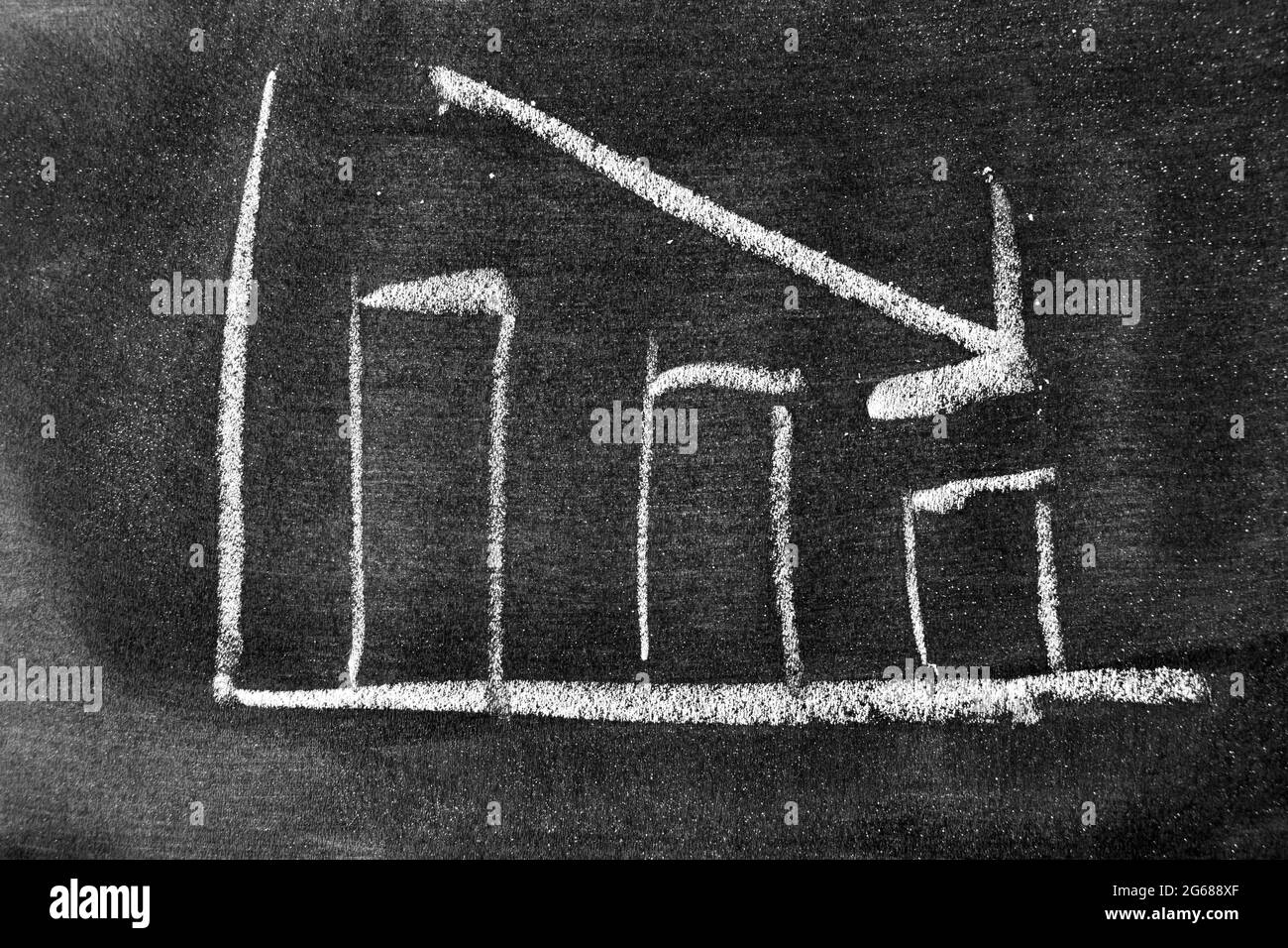 chalk board with sketch of decreasing business graph... White chalk hand drawing in arrow down shape on blackboard or ...