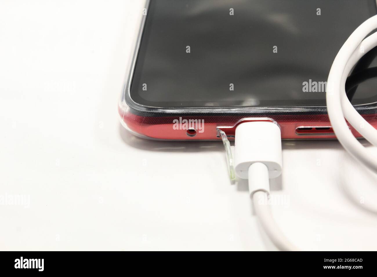 Smartphone charging cable attached on smartphone point, new smartphone charging concept Stock