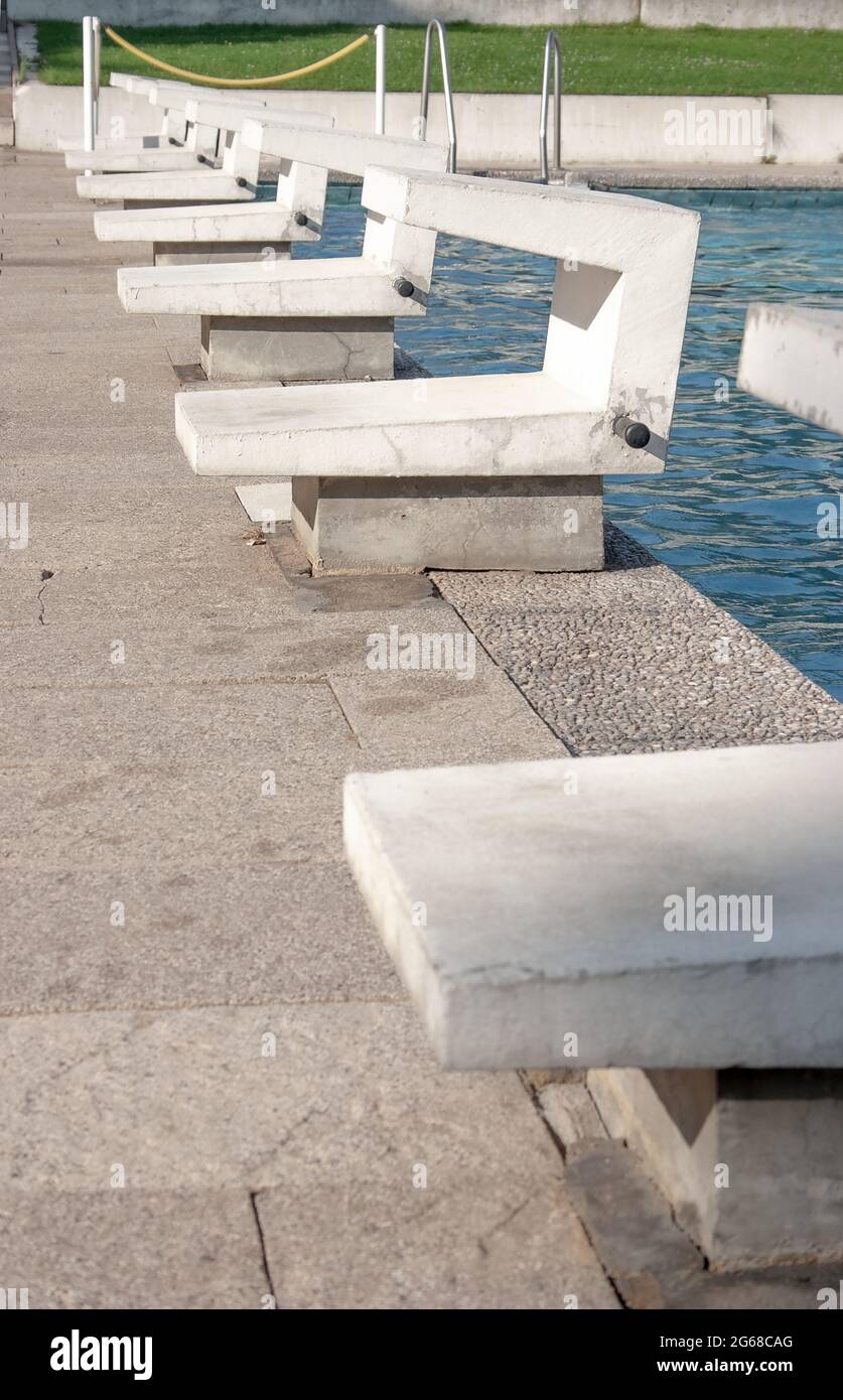 Starting blocks in an old public outdoor swimming pool in need of renovation Stock Photo