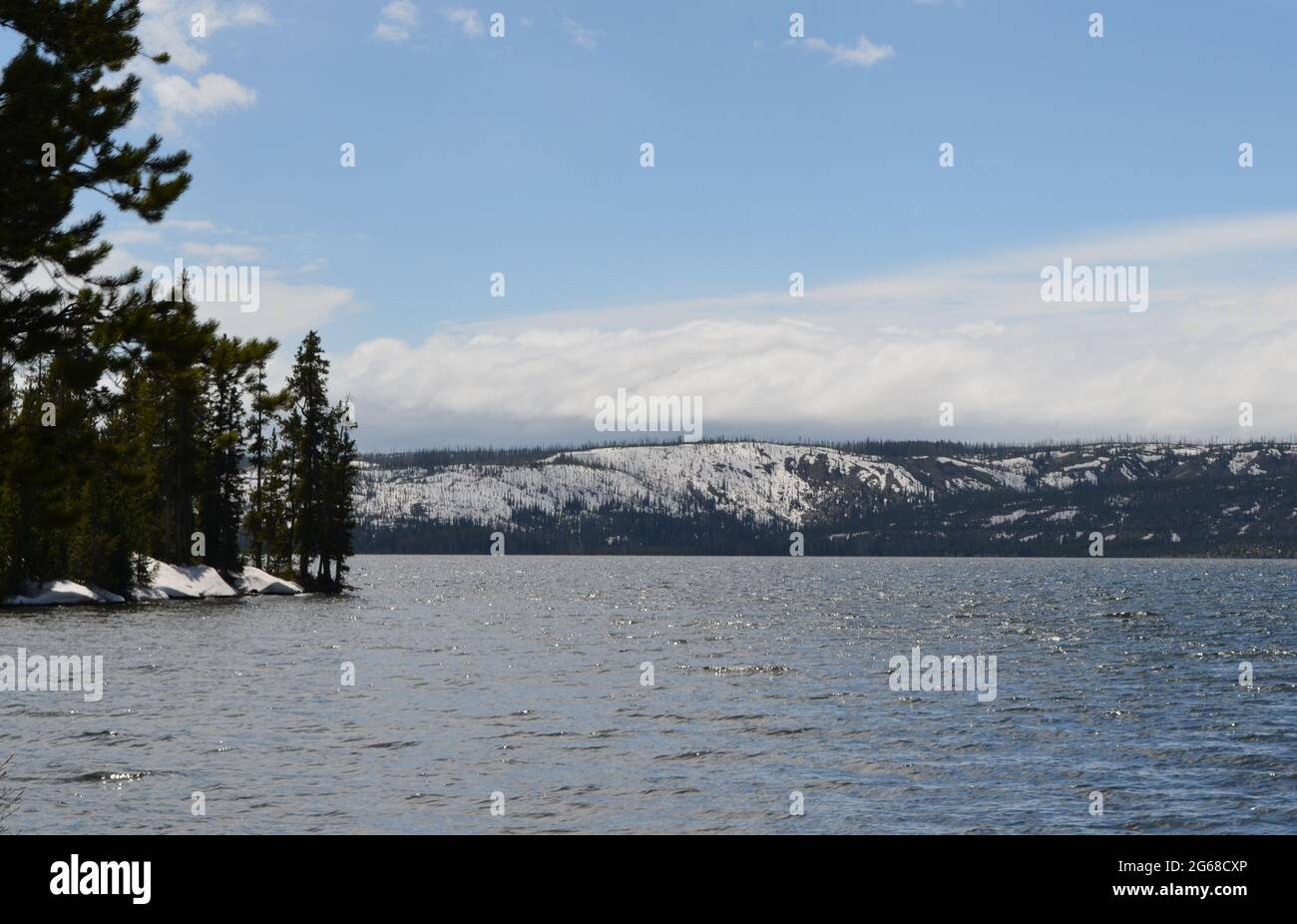 Late Spring in Yellowstone National Park: Lewis Lake Still Ringed by Snow As Seen from Along the South Entrance Road Stock Photo