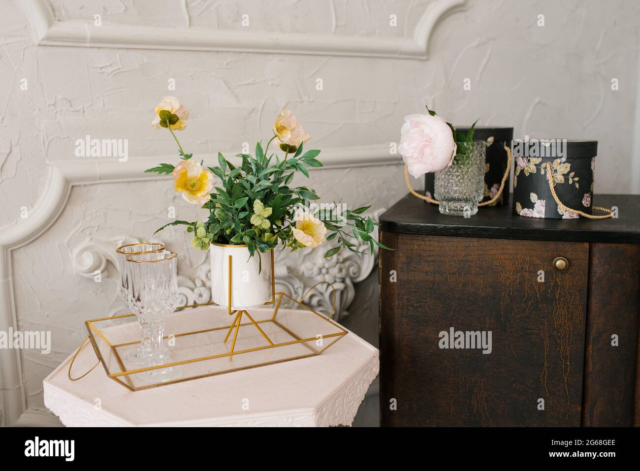 Decorative yellow poppy flowers in a white vase in the decor of the bedroom or living room in the house Stock Photo