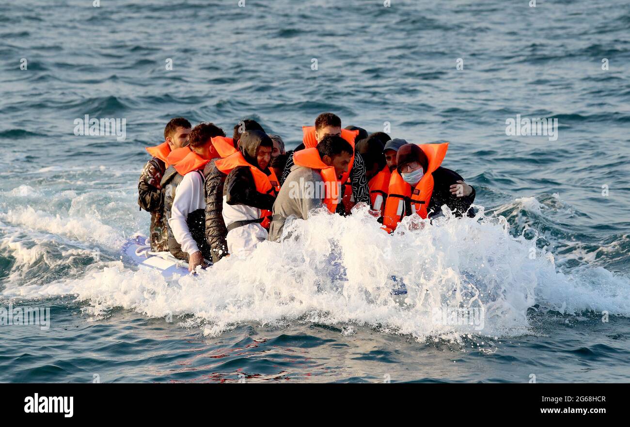 File photo dated 10/8/2020 of group of people thought to be migrants crossing the Channel in a small boat headed in the direction of Dover, Kent. Migrants seeking to make their way to the UK on small boats, and their people-smuggling enablers, will face heavier prison sentences in a bid to prevent 'asylum shopping', the Home Office has announced. Issue date: Sunday July 4, 2021. Stock Photo