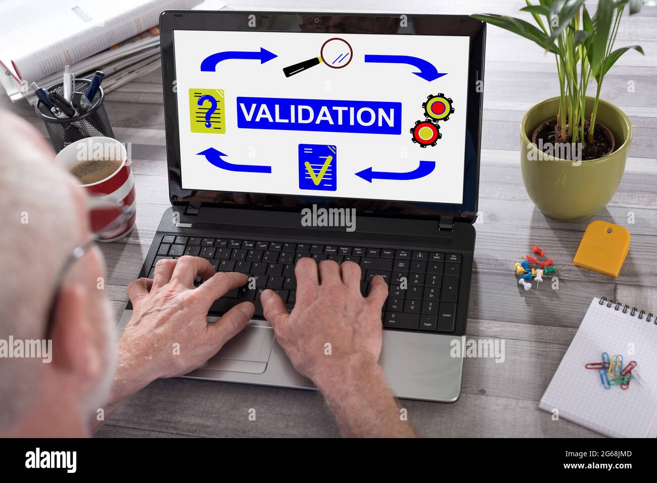 Validation concept shown on a laptop used by a man Stock Photo