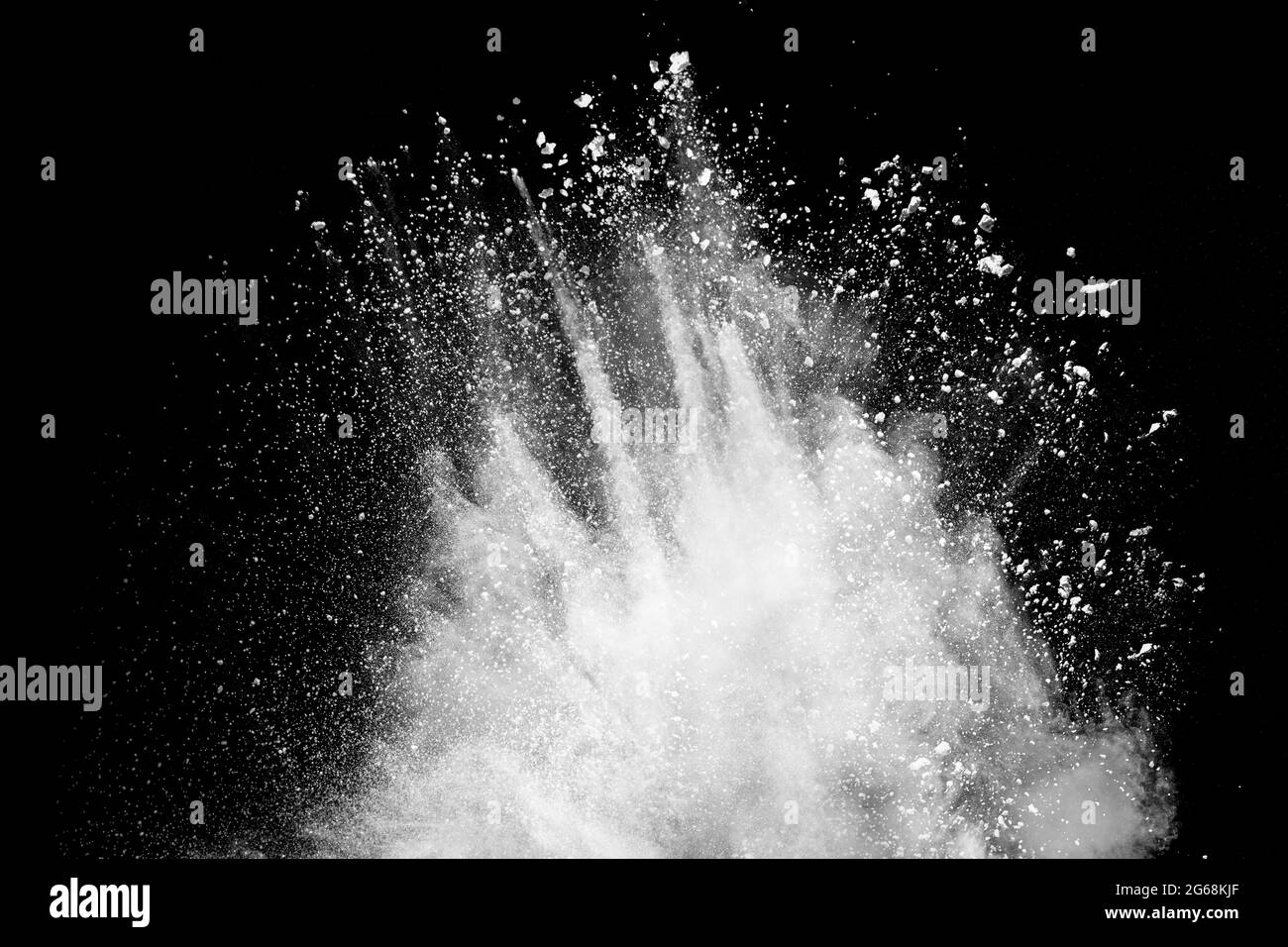 White powder explosion clouds.Freeze motion of white dust particles splash. Stock Photo