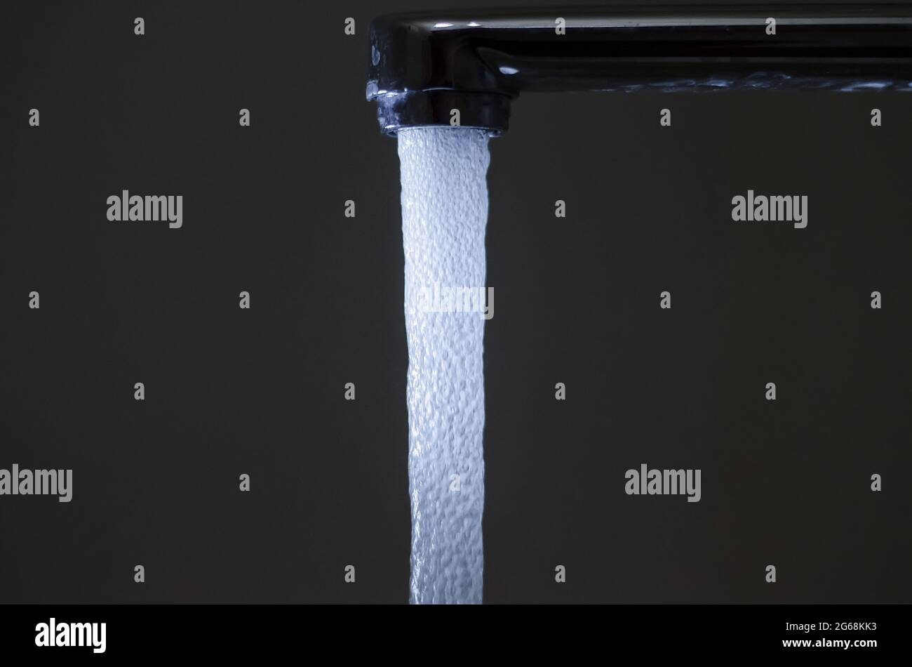 Water with bubbles flows down from the water tap Stock Photo Alamy