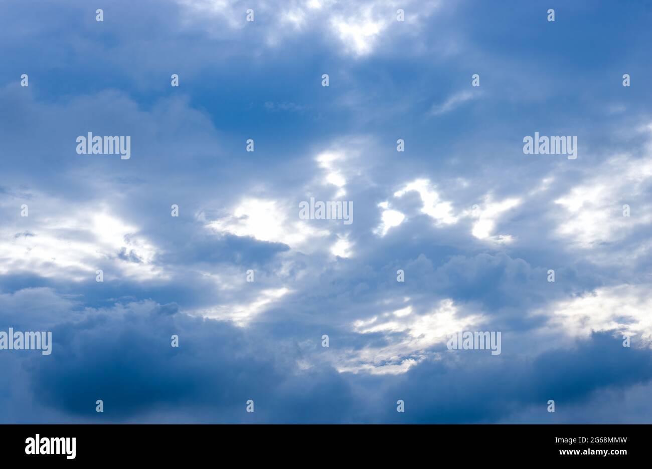 Dark blue clouds under the sunny sky before rain Stock Photo Alamy