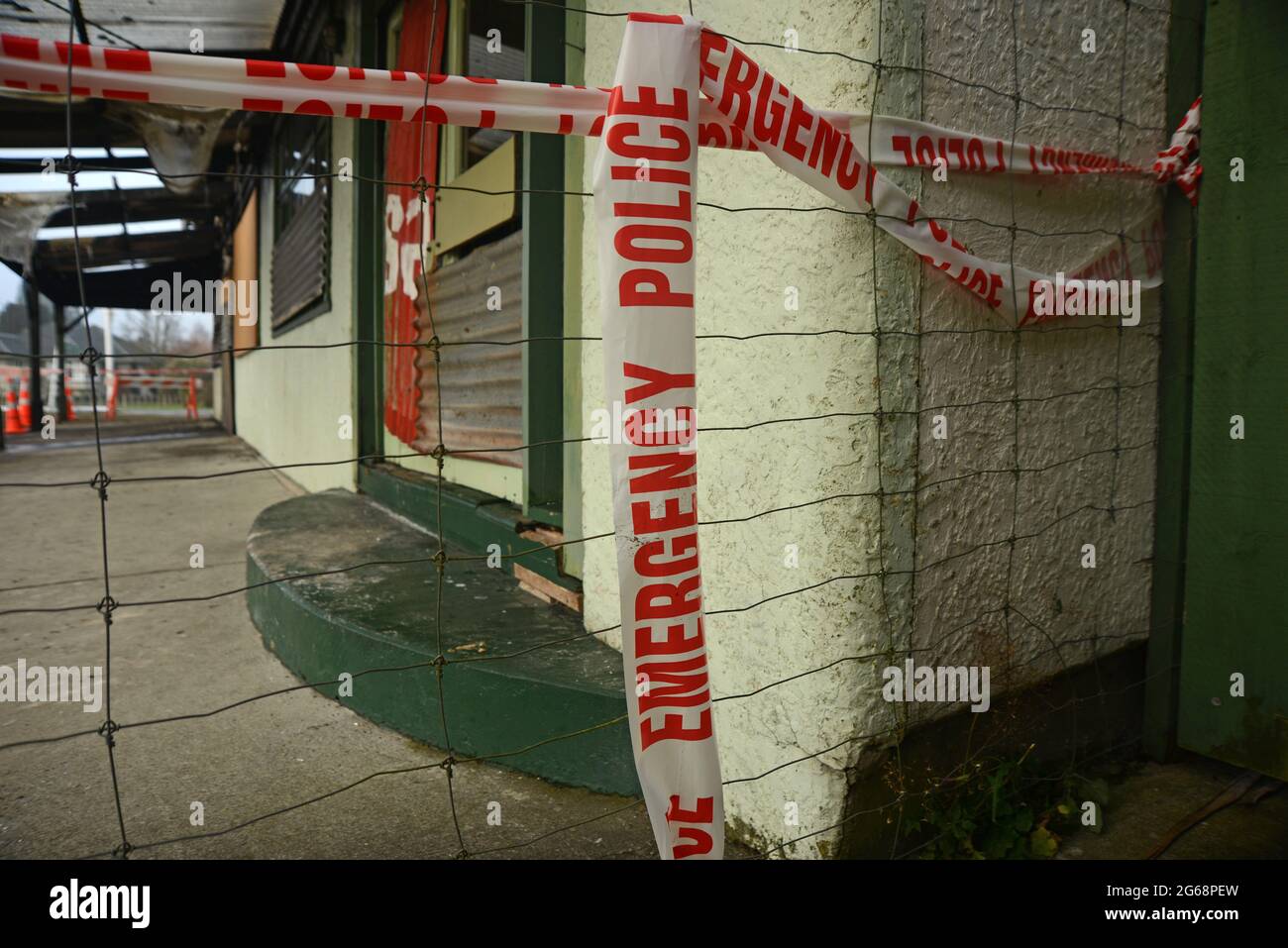 police emergency tape prevents public access at a suspected crime scene still under investigation Stock Photo