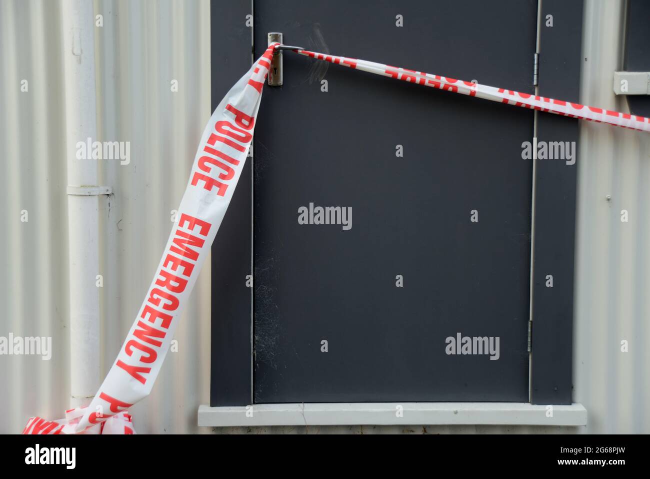 police emergency tape prevents public access at a suspected crime scene still under investigation Stock Photo